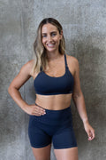 Mum wearing Moco Leisure Mum breastfeeding bra in Midnight Tide - sleek fit removable cups adjustable straps medium high support