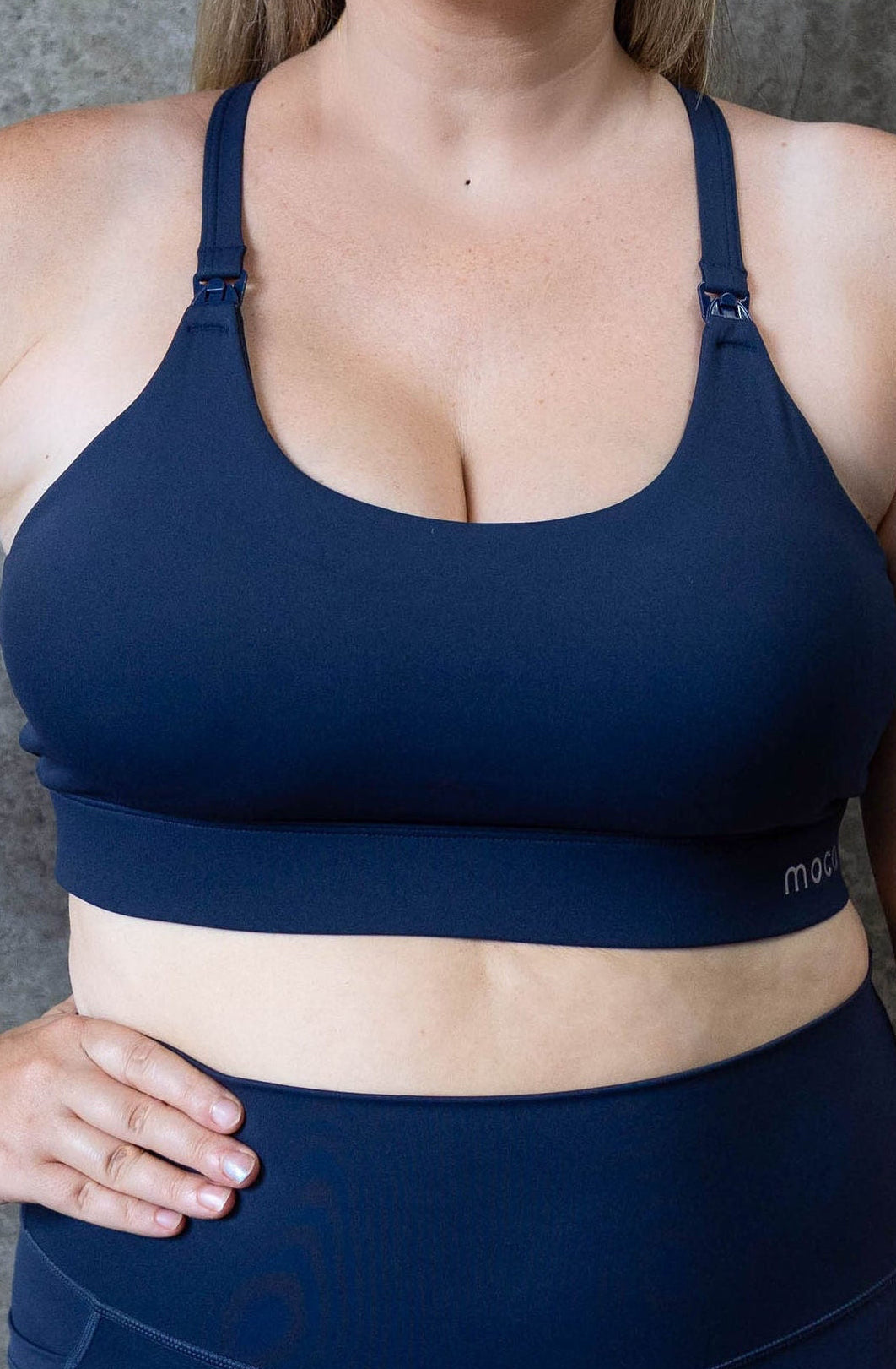 Mum wearing Moco nursing sports bra in Midnight Tide - removable cups adjustable straps medium high support breastfeeding bra